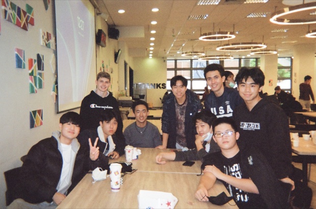 Friends gathered around a cafeteria table
